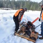 Volunteers prepare a mobile thrower before the start of the 21st annual Legislative Shoot on Saturday, March 17, 2018 at the Juneau Gun Club. (James Brooks | Juneau Empire)