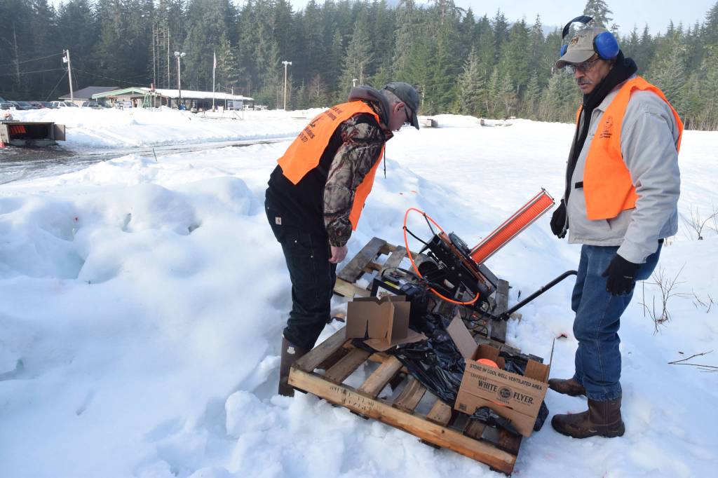Volunteers prepare a mobile thrower before the start of the 21st annual Legislative Shoot on Saturday, March 17, 2018 at the Juneau Gun Club. (James Brooks | Juneau Empire)