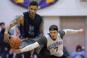 Klukwan’s Tony Tompkins, right, attempts a steal against Hydaburg’s Damen Bell-Holter in their B bracket game at the Juneau Lion’s Gold Medal Basketball Tournament at Juneau-Douglas High School on Monday, March 19, 2018. Klukwan won 65-61. (Michael Penn | Juneau Empire)