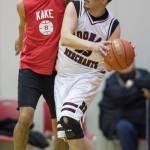 Kake&rsquo;s Lloyd Davis, right, is fouled by Hoonah&rsquo;s Ken Willard Jr. in the Master&rsquo;s bracket of the the Juneau Lion&rsquo;s Gold Medal Basketball Tournament at Juneau-Douglas High School on Monday, March 19, 2018. (Michael Penn | Juneau Empire)