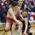 Maria Tulik, left, and Yakutat&rsquo;s Kim Buller scramble for a loose ball during their Women&rsquo;s bracket game in the Juneau Lion&rsquo;s Gold Medal Basketball Tournament at Juneau-Douglas High School on Tuesday, March 20, 2018. Yakutat won the game 60-52. (Michael Penn | Juneau Empire)