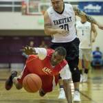 Kake&rsquo;s Kip Howard dives for the ball in front of Yakutat&rsquo;s Frank Jack in the Masters bracket in the Juneau Lion&rsquo;s Gold Medal Basketball Tournament at Juneau-Douglas High School on Wednesday, March 21, 2018. Kake won 60-50. (Michael Penn | Juneau Empire)