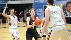 Juneau-Douglas&rsquo; Kolby Hoover drives during JDHS&rsquo; ASAA/First National Bank Alaska state basketball tournament game Thursday at the Alaska Airlines Center in Anchorage. (Michael Dinneen | For the Juneau Empire).