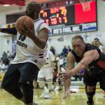 Klukwan&rsquo;s Chris Wassman, right, dives for a ball retrieved by Hoonah&rsquo;s Tierney Bible Sr. during their Master&rsquo;s bracket game in the Juneau Lion&rsquo;s Gold Medal Basketball Tournament at Juneau-Douglas High School on Thursday, March 22, 2018. (Michael Penn | Juneau Empire)