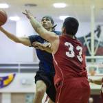 Hydaburg&rsquo;s Joe Young drives to the basket against Lance Doeake, center, and Rudy Bean in a B bracket game in the Juneau Lion&rsquo;s Gold Medal Basketball Tournament at Juneau-Douglas High School on Thursday, March 22, 2018. (Michael Penn | Juneau Empire)