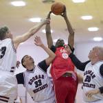 Kake&rsquo;s Kip Howard rebounds against Hoonah&rsquo;s Pete Schneeberger, left, Albert Hinchman, center, and Andy Gray in the Master&rsquo;s bracket final at the Juneau Lion&rsquo;s Gold Medal Basketball Tournament at Juneau-Douglas High School on Saturday, March 24, 2018. (Michael Penn | Juneau Empire)