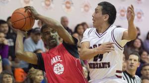 Kake&rsquo;s Kip Howard keeps the ball away from Hoonah&rsquo;s Ken Willard Jr. in the Master&rsquo;s bracket final at the Juneau Lion&rsquo;s Gold Medal Basketball Tournament at Juneau-Douglas High School on Saturday, March 24, 2018. (Michael Penn | Juneau Empire)