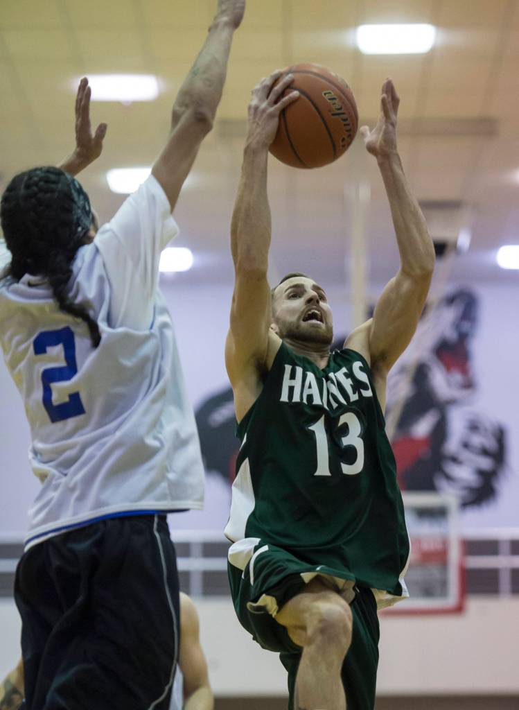 Haines&rsquo; Kyle Rush, right, shoots against Klukwan&rsquo;s Austin Shoemaker in the B Bracket final at the Juneau Lion&rsquo;s Gold Medal Basketball Tournament at Juneau-Douglas High School on Saturday, March 24, 2018. (Michael Penn | Juneau Empire)