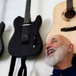 Guitar maker George Gress shares a laugh with a reporter at his home in Juneau on Tuesday, March 27, 2018 while discussing the differences between making acoustic versus electric guitars. Richard McGrail | For the Capital City Weekly