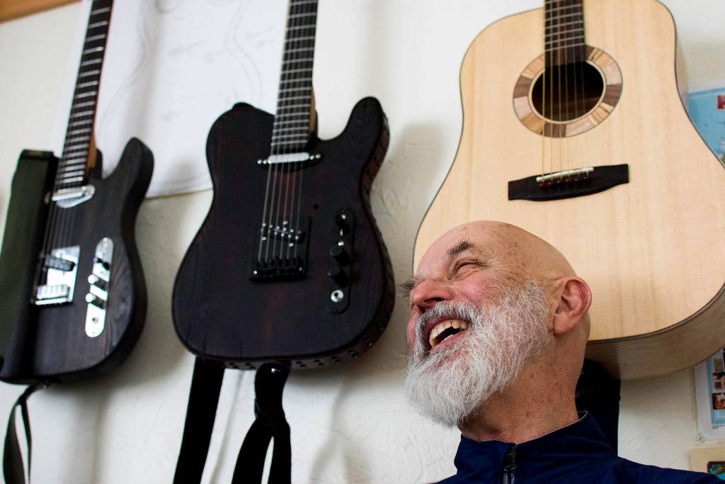 Guitar maker George Gress shares a laugh with a reporter at his home in Juneau on Tuesday, March 27, 2018 while discussing the differences between making acoustic versus electric guitars. Richard McGrail | For the Capital City Weekly