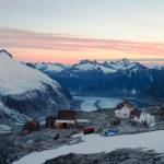 Camp 18 sits on a rock knob above the Gilkey Trench, as students take in the sunset on the Juneau Icefield, July 2017. Photo by Ben Huff.
