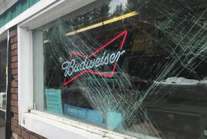 A front window of Duck Creek Market is cracked after a car crashed into the front of the building on Tuesday, March 27, 2018. (Alex McCarthy | Juneau Empire)