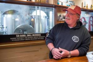 Tom West talks about his retirement from the Alaskan Brewing Company on Friday, March 30, 2018. West started with the company at its beginning, brewing beer in the ten-barrel tanks in the background. (Michael Penn | Juneau Empire)