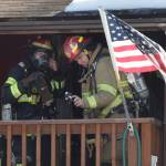 Two Capital City Fire/Rescue firefighters investigate a house fire in the Mendenhall Valley on Friday, March 30, 3018. (Alex McCarthy | Juneau Empire)