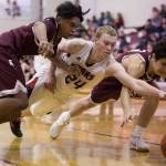 Juneau-Douglas&rsquo; Erik Kelly, center, dives for a ball against Ketchikan&rsquo;s Chris Lee, left, and James Nordlund at JDHS on Wednesday, Feb. 21, 2018. JDHS won 59-41.