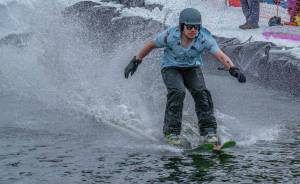 A slush cup participant skims across the water at the 2017 Eaglecrest Slush Cup. The ski area is not hosting the event this year, citing low snow levels. (Lance Nesbitt | For the Juneau Empire)