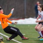 Juneau-Douglas&rsquo; Eva Goering scores against Ketchikan&rsquo;s goalie Ezrie Anderson at Thunder Mountain High School on Friday, April 6, 2018. JDHS won 8-0. (Michael Penn | Juneau Empire)