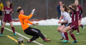 Juneau-Douglas&rsquo; Eva Goering scores against Ketchikan&rsquo;s goalie Ezrie Anderson at Thunder Mountain High School on Friday, April 6, 2018. JDHS won 8-0. (Michael Penn | Juneau Empire)