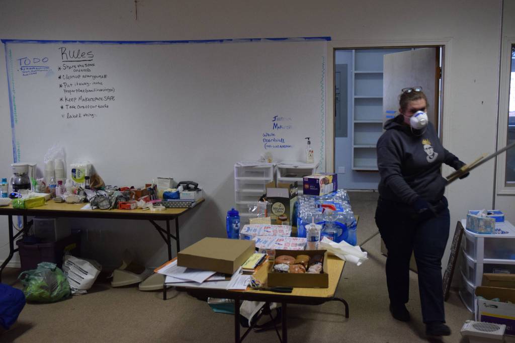 Stephanie Andrew, a board member for Juneau Makerspace, takes construction materials out of a space that will become a woodshop at the nonprofit&rsquo;s new location during a work party Saturday. Juneau Makerspace is currently renovating an old church on North Douglas Highway, turning it into a mult-purpose workshop, studio and event venue. (Kevin Gullufsen | Juneau Empire)