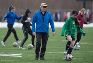 Co-coach John Newell leads his team through drills during Thunder Mountain High School girls varsity soccer practice at TMHS on Monday. (Michael Penn | Juneau Empire)