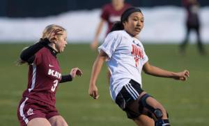 Juneau-Douglas&rsquo; Malia Miller controls the ball against Ketchikan&rsquo;s Sydney Nichols at Thunder Mountain High School on Friday, April 6, 2018. (Michael Penn | Juneau Empire)