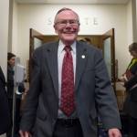 Sen. Dennis Egan, D-Juneau, walks out of the Senate chambers and to a reception to honor him and Sen. Berta Gardner, D-Anchorage, at the Capitol on Wednesday, April 11, 2018. Both are retiring from the legislature this year. (Michael Penn | Juneau Empire)