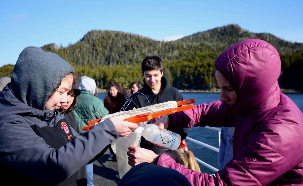 Chohla Moll helps students with plankton sampling near Middle Island, an important place for harvesting herring eggs. Maia Mares | For the Capital City Weekly Chohla Moll helps students with plankton sampling near Middle Island, an important place for harvesting herring eggs. Maia Mares | For the Capital City Weekly