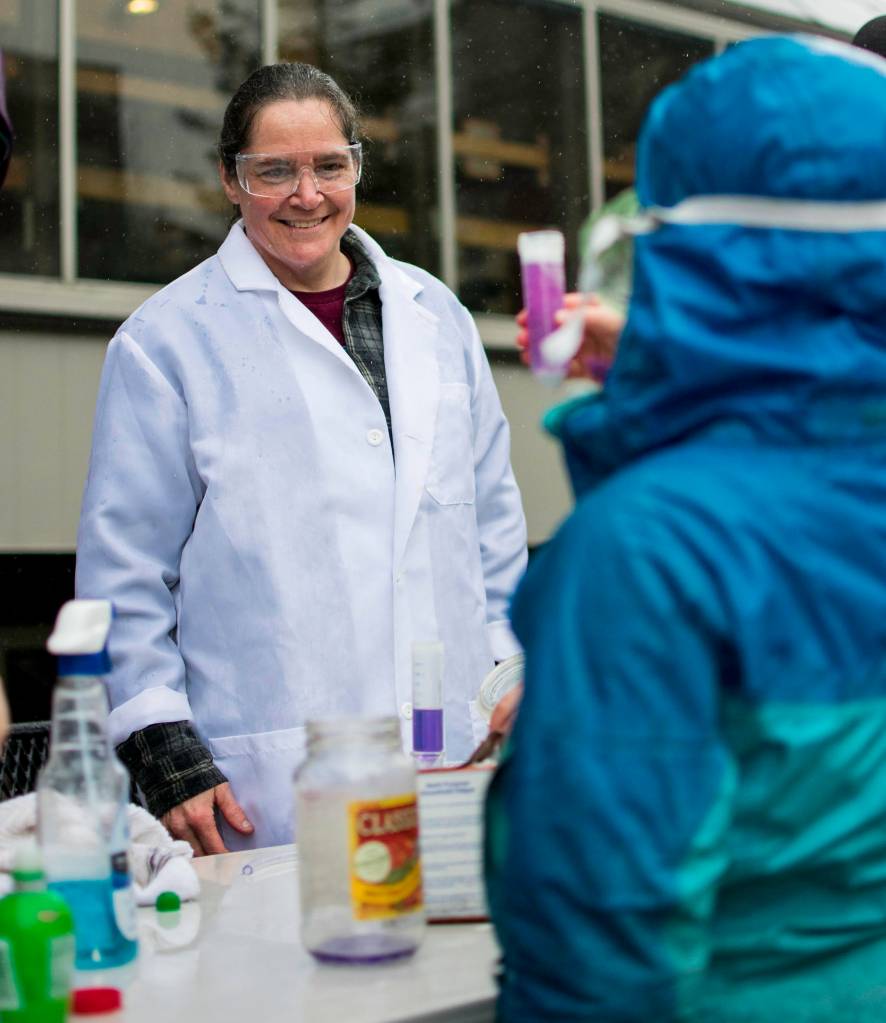 Susan Kending helps students learn about chemical reactions outside the Alaska Capitol on Saturday, April 14, 2018. Susan was part of a group of demonstrators expressing support for science and education.