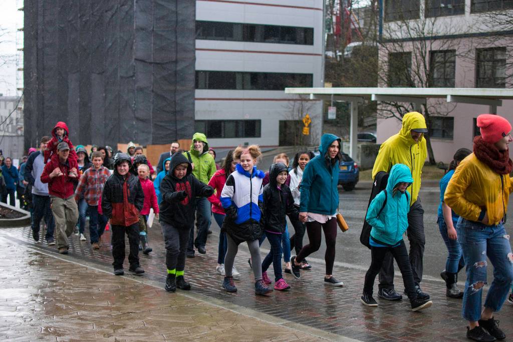 A group of demonstrators approaches the Alaska Capitol during the March for Science rally on Saturday, April 14, 2018. (Richard McGrail | Juneau Empire)