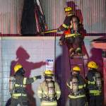 Juneau Capital City Fire/Rescue firefighters work a building fire at North Franklin and Second Street on Monday, April 16, 2017. (Michael Penn | Juneau Empire)