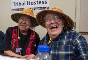 Tribal Hostess Bertha Karras, of Sitka, left, and Tribal Host Fred Hamilton Sr., of Craig, share a laugh at the 83rd Annual Tribal Assembly of the Central Council of the Tlingit and Haida Indian Tribes of Alaska at Elizabeth Peratrovich Hall on Wednesday, April 18, 2018. (Michael Penn | Juneau Empire)