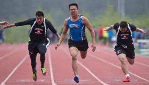 Thunder Mountain&rsquo;s Erick Whisenant, center, pushes ahead of Juneau-Douglas&rsquo; Ulyx Bohulano, left, and Lance Fenumiai in a preliminary 100-meter dash at the Region V Track and Field meet at Thunder Mountain High School on May 19, 2017. (Michael Penn | Juneau Empire File)