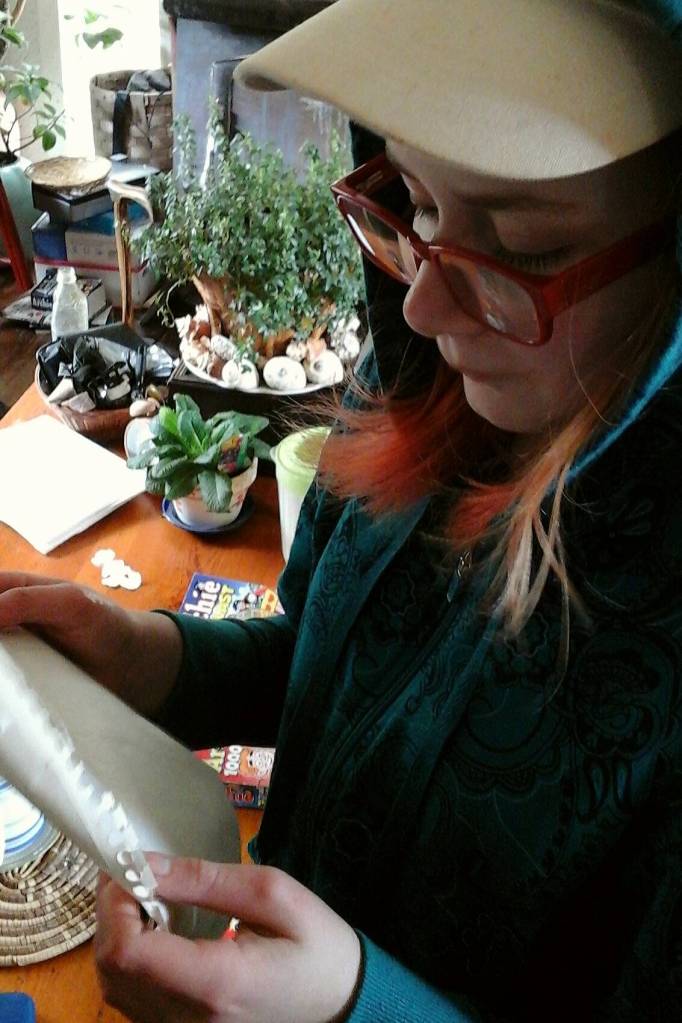 A.C. Dearden reads the message written in April last year. Tara Neilson | For the Capital City Weekly