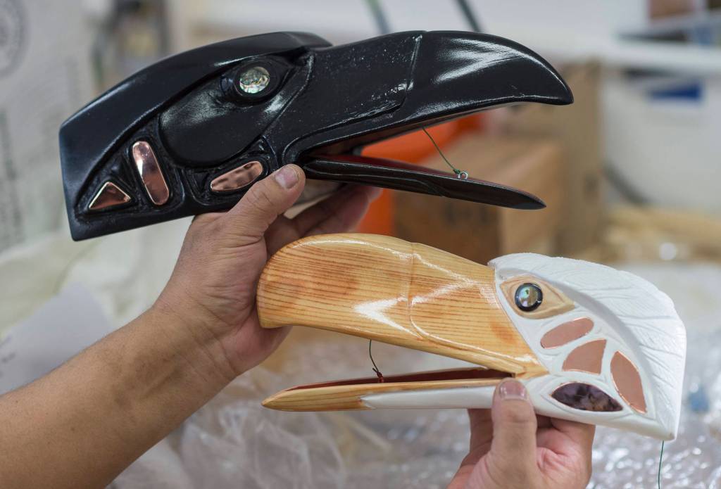 An inmate displays masks he made in a workshop taught by master carver Ray Watkins at Lemon Creek Correctional Center on Monday, April 13, 2018. (Michael Penn | Juneau Empire)