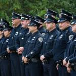 In this file photo, Juneau Police Department officers pose for a picture during the September 11th Memorial ceremony at Rotary Park. JPD will receive funds for domestic violence expert training through a Juneau Community Foundation grant, announced today. (Michael Penn | Juneau Empire)