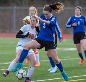 Thunder Mountain&rsquo;s Macey Fuette, right, takes the ball from West&rsquo;s Julia Johnson at TMHS on Friday. (Michael Penn | Juneau Empire)