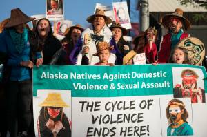 Demonstrators march in the Violence Against Women Awareness Rally near Elizabeth Peratrovich Hall on Friday, April 20, 2018. (Richard McGrail | Juneau Empire)