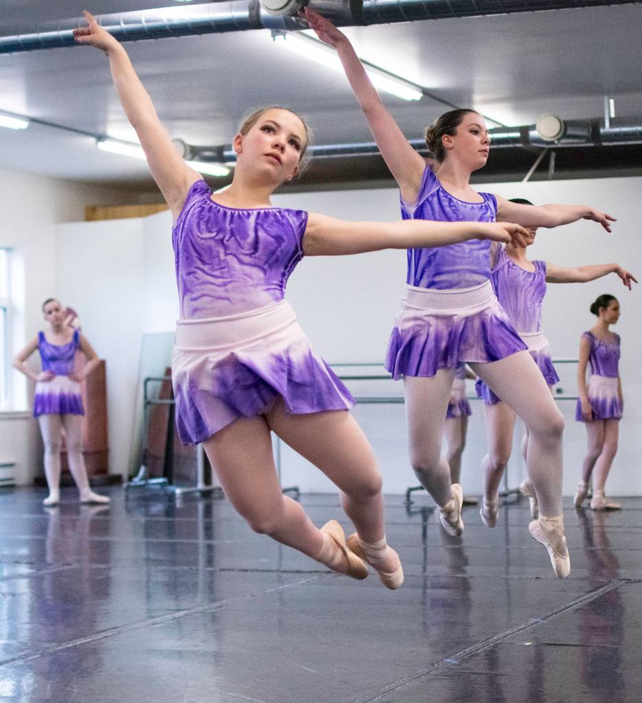 Elin Antaya, left, and Jillian Anderson leap accross the floor while rehearsing &ldquo;Then the Rain Turned Purple&rdquo; at the Juneau Dance Theatre on Sunday, April 22, 2018. Richard McGrail | For the Capital City Weekly