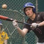 Senior Sammy McKnight works on his bunting skills as junior Cameron Eppers, background, waits his turn during Thunder Mountain High School baseball practice at the Wells Fargo Dimond Park Fieldhouse on Tuesday, April 24, 2018. (Michael Penn | Juneau Empire)
