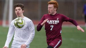 Thunder Mountain&rsquo;s Jake Babcock, left, drives the ball down field against Ketchikan&rsquo;s Max Collins at TMHS on Thursday. (Michael Penn | Juneau Empire)