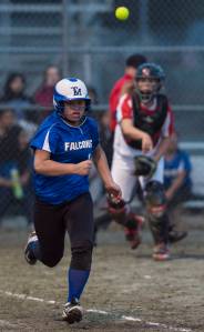 Thunder Mountain&rsquo;s Mariah Tanuvasa Tuvaifale, left, is thrown out running to first by Juneau-Douglas&rsquo; Slylar Hickok at Dimond Park on Friday, April 27, 2018. TMHS won 11-4. (Michael Penn | Juneau Empire)