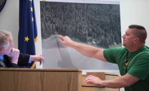 Witness Seth Bradshaw points to where he found the body Duilio Antonio &ldquo;Tony&rdquo; Rosales at an Excursion Inlet cabin while Juneau Superior Court Judge Philip Pallenberg holds a map during the trial of Mark De Simone in Juneau Superior Court on Monday, April 30, 2018. De Simone is accused of killing Rosales during a hunting trip in Excursion Inlet in 2016. Bradshaw was the first person to find Rosales. (Michael Penn | Juneau Empire)