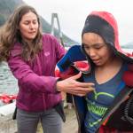 Dzantik&rsquo;i Heeni Middle School sixth-grade receives help getting out of a wet survival suit by teacher Cheyenne Cuellar during a class from the Alaska Marine Safety Education Association at the U.S. Coast Guard&rsquo;s Station Juneau dock on Monday, April 30, 2018. (Michael Penn | Juneau Empire)