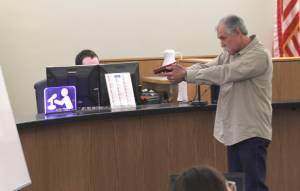 Chad Kendrick, firearm instructor and owner of Taku Tactical in Juneau, performs a firearm demonstration for members of the jury in the murder trial of Mark De Simone on May 8, 2018. De Simone is accused of killing Duilio Antonio &ldquo;Tony&rdquo; Rosales during a hunting trip in Excursion Inlet in 2016. (Alex McCarthy | Juneau Empire)