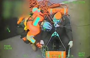 A Coast Guard Air Station Sitka helicopter crew prepares to hoist a 61-year-old man from a tugboat in Chatham Strait on May 9, 2018. The man was experiencing stroke-like symptoms. (Coast Guard Air Station Sitka | Courtesy Photo)