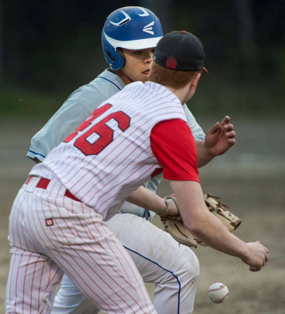 Juneau-Douglas&rsquo;s drops the ball while attempting to tag Thunder Mountain&rsquo;s Chris San Nicolas at third base at Adair-Kennedy Memorial Park on Tuesday, May 15, 2018. (Michael Penn | Juneau Empire)