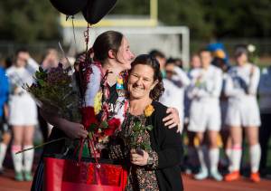 Juneau-Douglas&rsquo; Bianca Eagan receives gifts from her mother, Cynthia, for Senior Night at Adair-Kennedy Memorial Park on Tuesday, May 15, 2018. (Michael Penn | Juneau Empire)