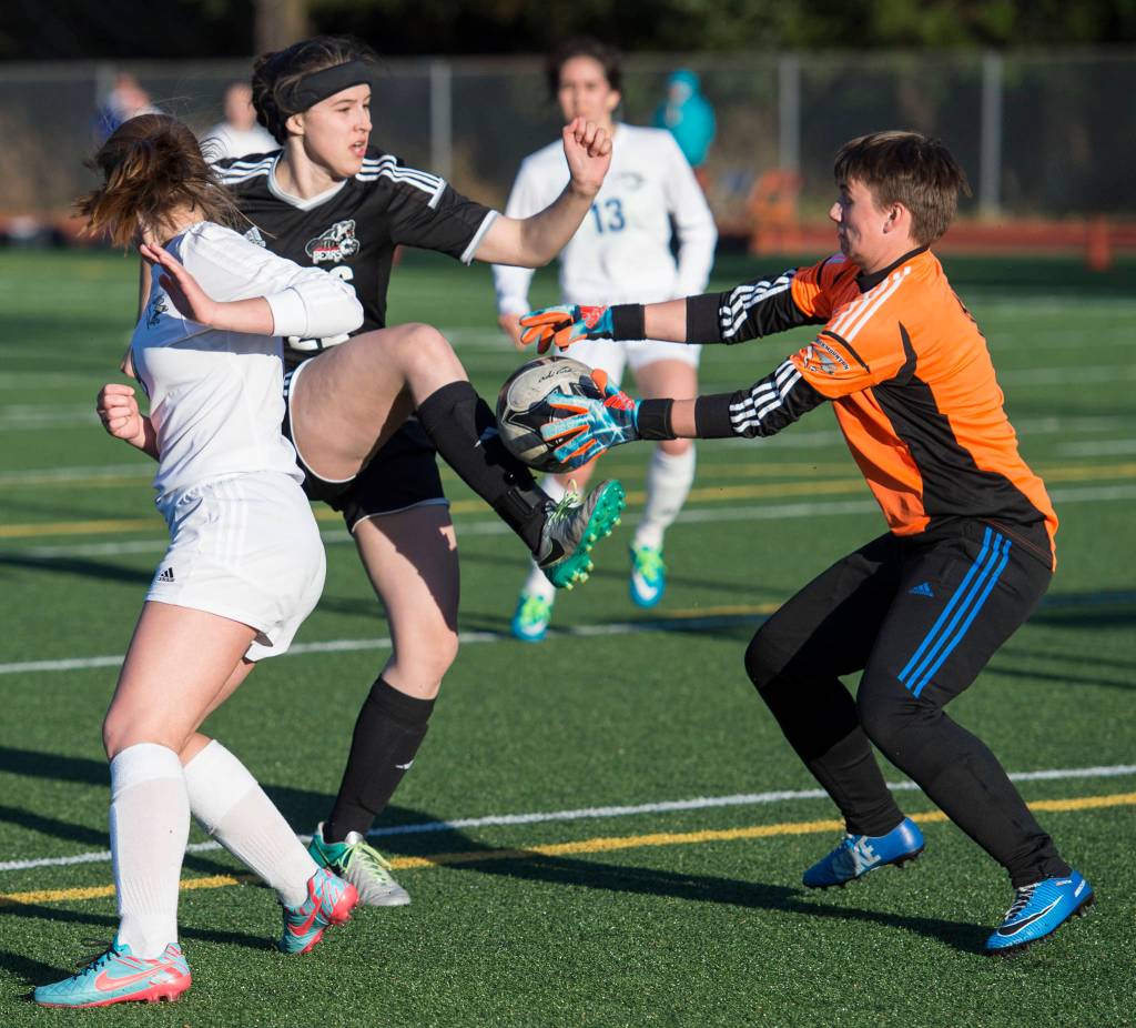 Juneau-Douglas&rsquo; Nikki Box has her point-blank shot blocked by Thunder Mountain&rsquo;s keeper Karson Sutak at Adair-Kennedy Memorial Park on Tuesday, May 15, 2018. (Michael Penn | Juneau Empire)