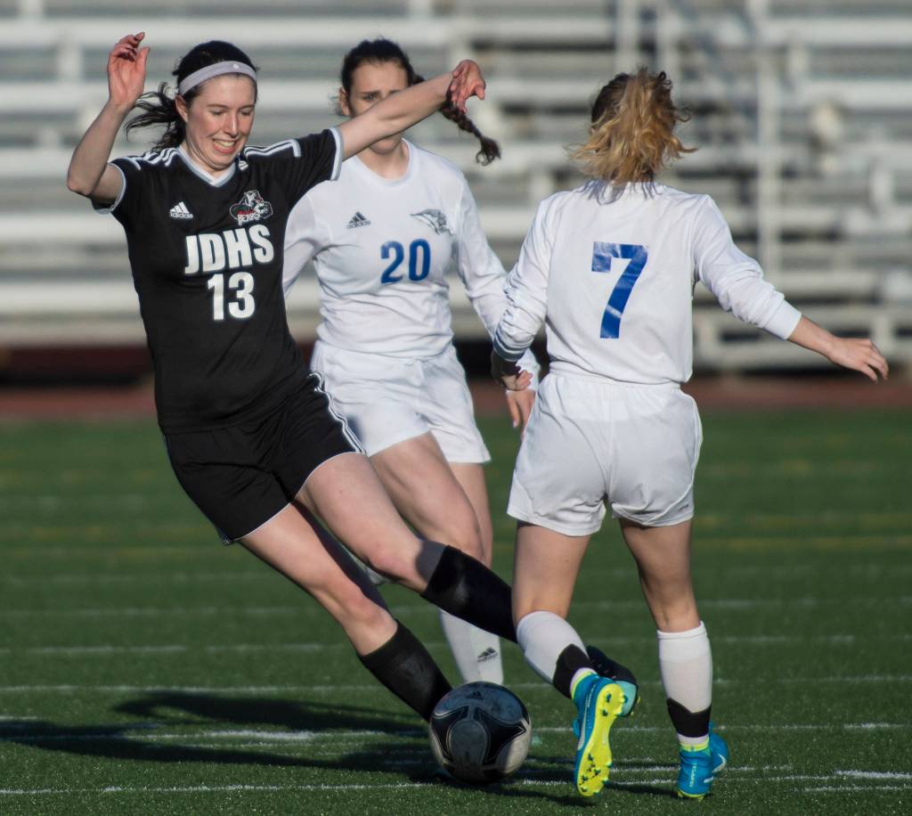 Juneau-Douglas&rsquo; Nicole Mannix, left, drives against Thunder Mountain&rsquo;s Raye Coffee at Adair-Kennedy Memorial Park on Tuesday, May 15, 2018. (Michael Penn | Juneau Empire)