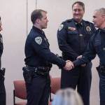 Juneau Police Department Chief Ed Mercer, right, congratulates Deputy Chief David Campbell, second from right, Lt. Krag Campbell, and Sgt. Ben Beck, left, during a promotions ceremony at the police station on Monday, Oct. 30, 2017. (Michael Penn | Juneau Empire File)
